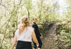 Two women walking through the forest together